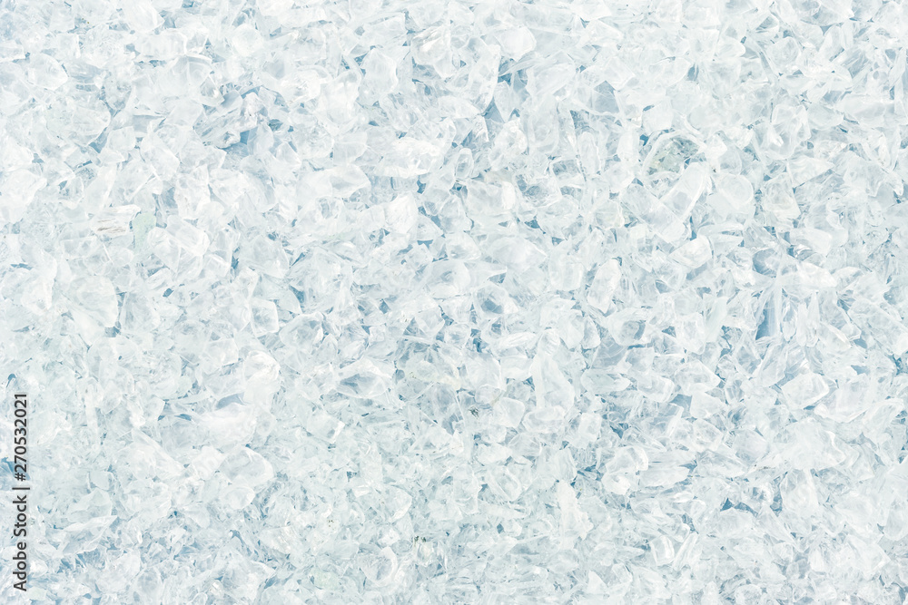Fototapeta premium Texture of shattered small white glass fragments. Background of sharp glass pieces ready to be remelted.