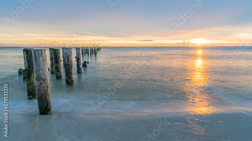pier at sunset at wonderful beach near Naples  Florida