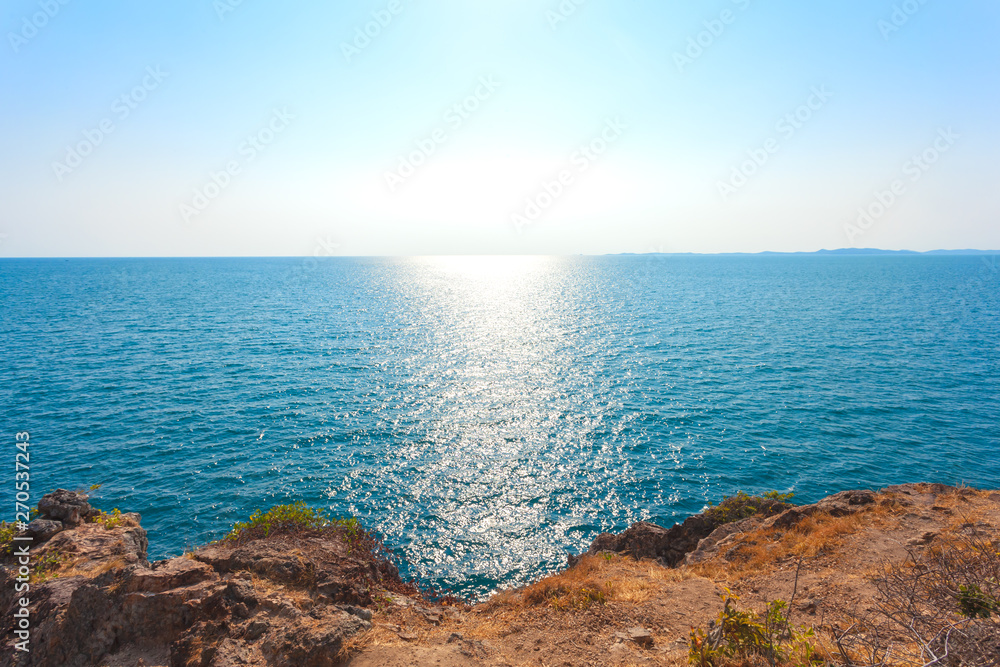 Beach with stone and sea with sun rises reflection .in the spring day Beach with stone and sea with sun rises reflection .in the spring day