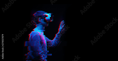Man is using virtual reality headset. Image with glitch effect. photo