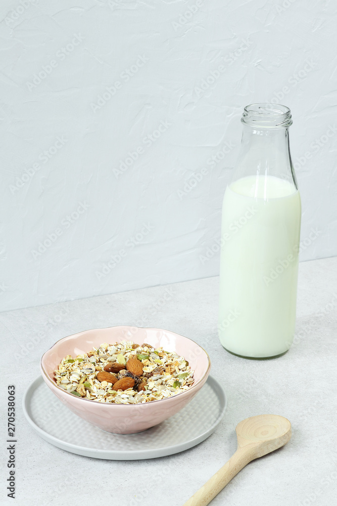 Muesli with milk on grey table Muesli with milk on grey table