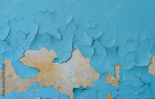 The old cracked blue paint on a wall surface