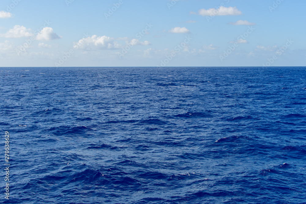 Blue sky with white clouds over the azure waters of the ocean. Blue sky with white clouds over the azure waters of the ocean.