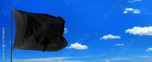 Εκτύπωση καμβά Conceptual image of waving blank black flag over sunny blue sky