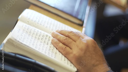 Old Man hand on tehillim book. Read tehillim in king david grave. Jerusalem, israel. photo