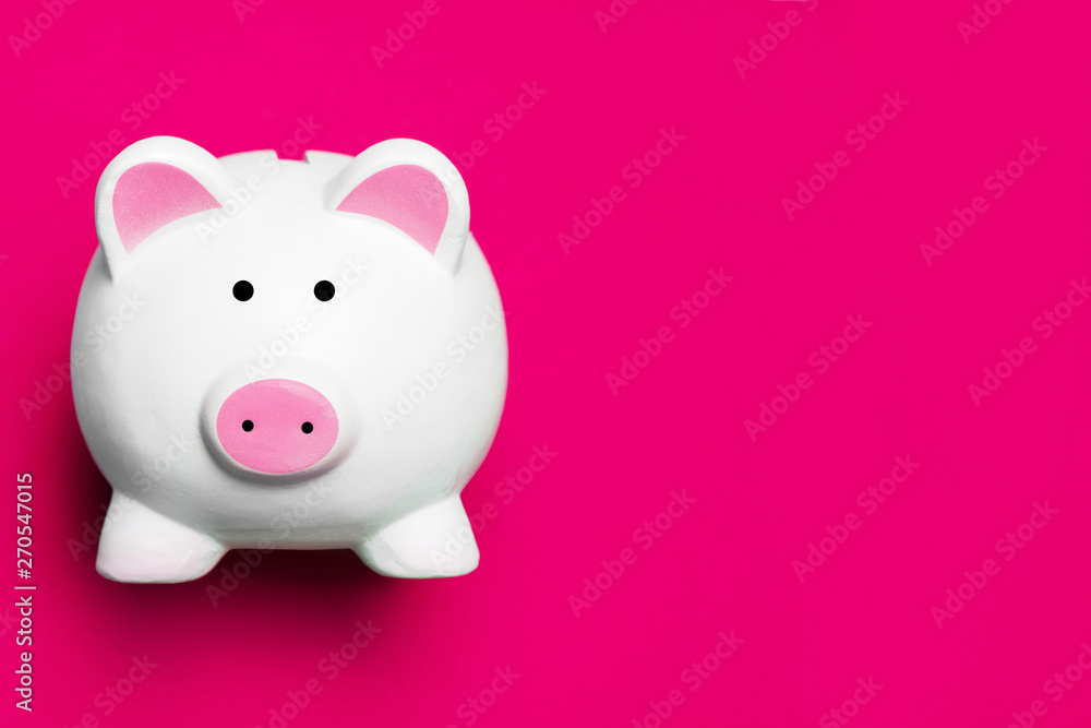 White piggy bank isolated on pink. Money saving background.