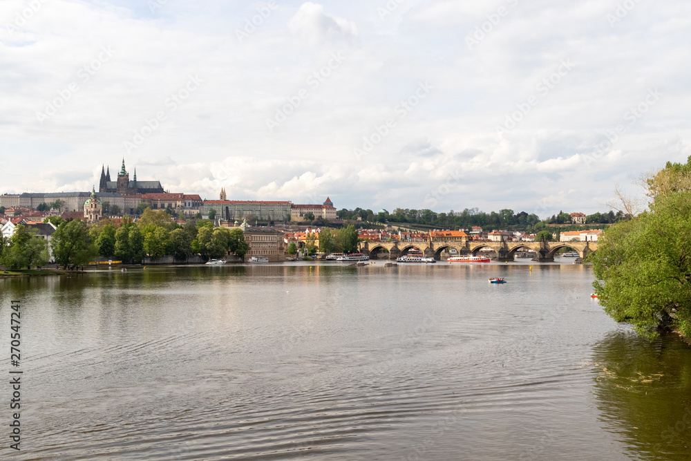 Spring view of Vltava river, boats and city view of Prague / Prague, Czech Republic, May 2019