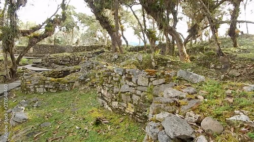 shot from Machu Picchu, with aged walls and structures constructed around hills  photo