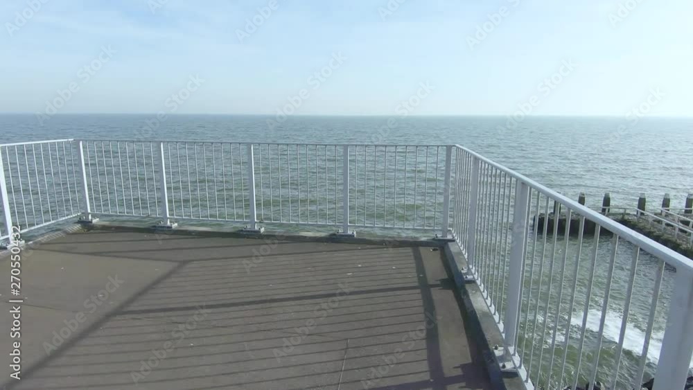 Descend the stairs to the observation deck overlooking the sea. Descend the stairs to the observation deck overlooking the sea.