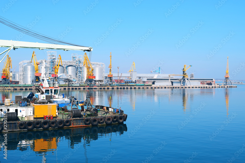Fototapeta premium Industrial port on the black sea. Tugboat on the background of the seaport