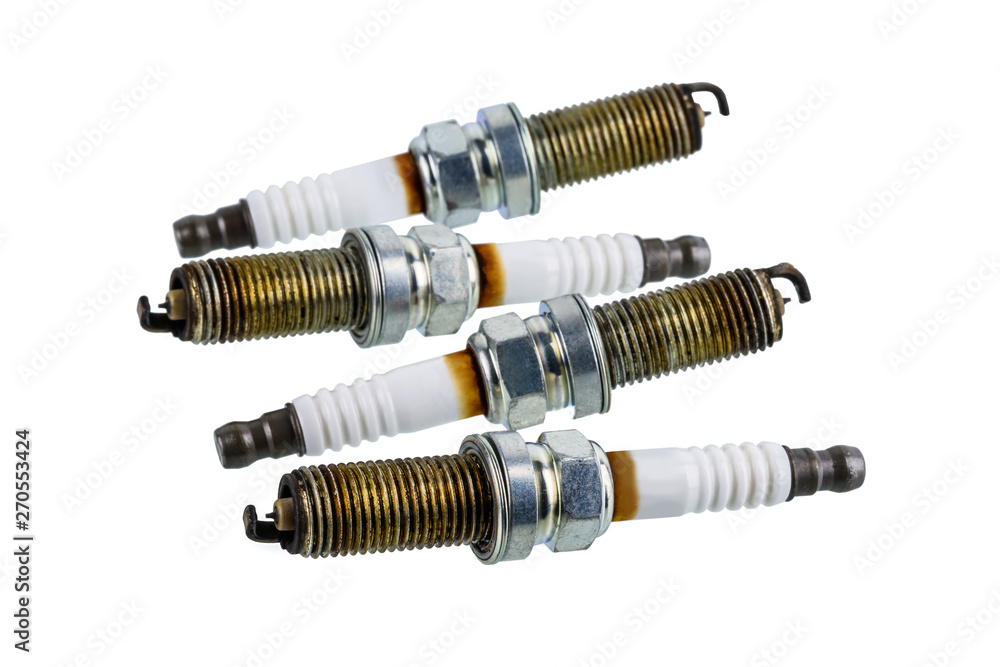Car spark plugs that have been used for more than 10,000 kilometers isolated on white Car spark plugs that have been used for more than 10,000 kilometers isolated on white