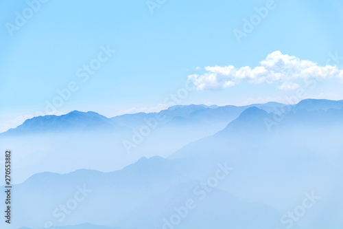 Fototapeta Naklejka Na Ścianę i Meble -  Abstract cascade mountain chains silhouette landscape nackground in a light blue mist sky in morning Andes