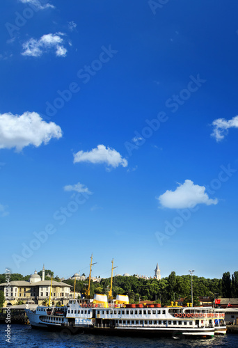 Cityscape image of Istanbul Bosphorus view with old ferry ships over clear blue sky in Turkey © jokerpro