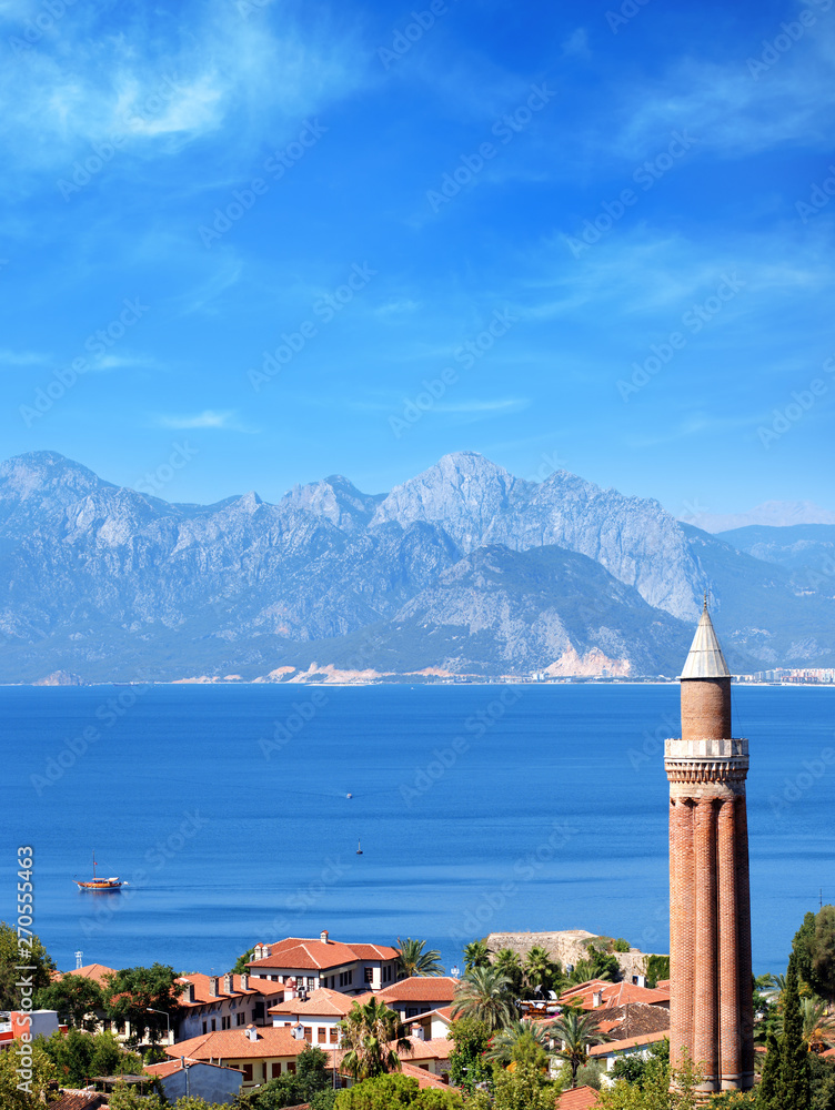 Fototapeta premium elevated view of cityscape image of historic district of Antalya over Mediterranean sea and high mountains with clear blue sky in Turkey