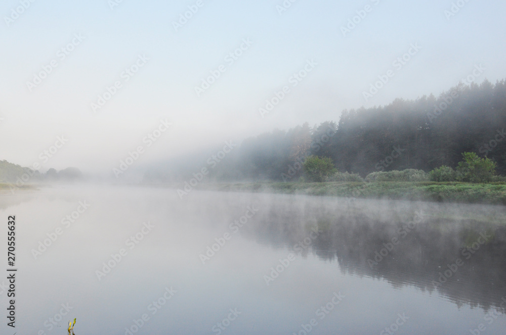 Photo of fog over the river in the early summer morning