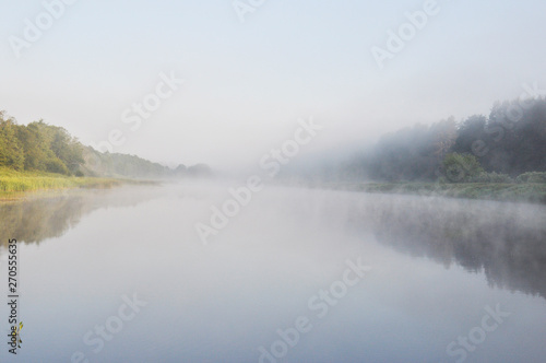 Photo of fog over the river in the early summer morning