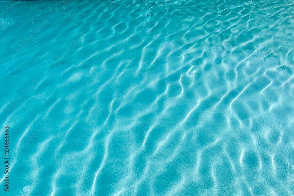 Surface of rippled blue swimming pool