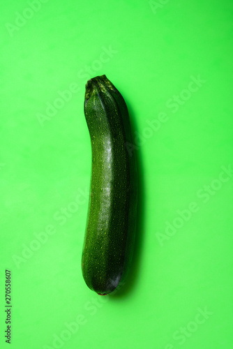Green zucchini on green background
