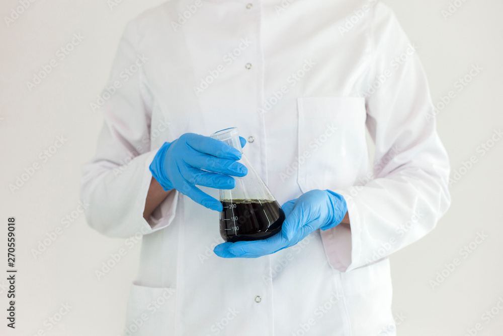Scientist tearing the CBD oil with a precise dropper from a bowl into a tube Scientist tearing the CBD oil with a precise dropper from a bowl into a tube