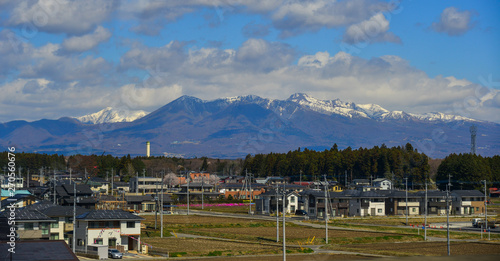Cityscape with snow mountain in sunny day © Phuong