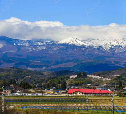 Cityscape with snow mountain in sunny day
