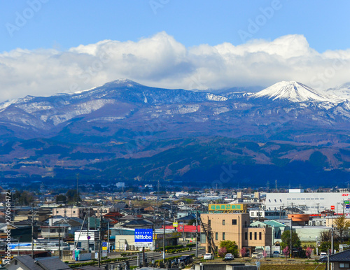 Cityscape with snow mountain in sunny day