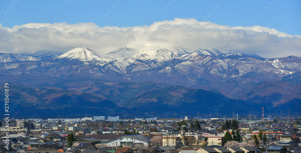 Fototapeta premium Cityscape with snow mountain in sunny day