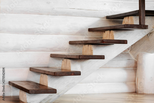 a wooden staircase with a wooden log in the house photo