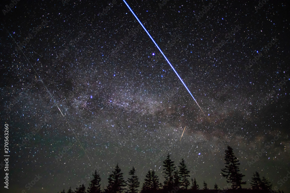 Flying through the night sky of the space station of satellites and meteors