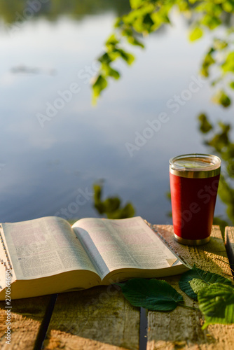 Devotional time outdoors: the Bible and a travel mug