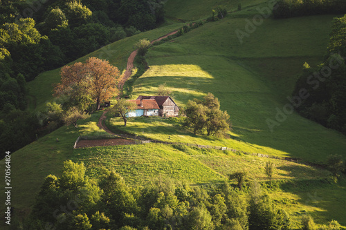 Beautiful summer green hills in Transylvania. Sunrise landscape in the Romanian mountain village