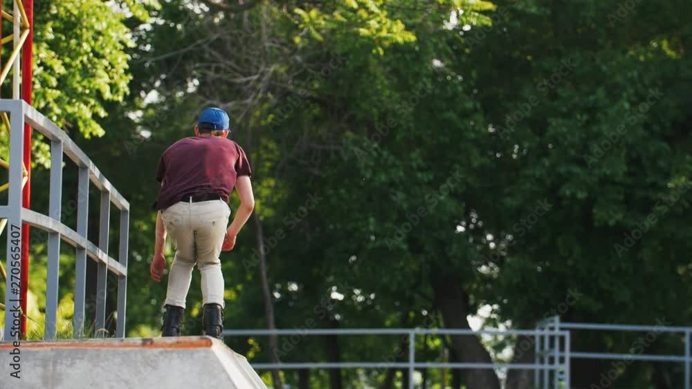 Aggressive Inline roller skater doing tricks in concrete skatepark outdoors with beautiful background, super slow motion Aggressive Inline roller skater doing tricks in concrete skatepark outdoors with beautiful background, super slow motion