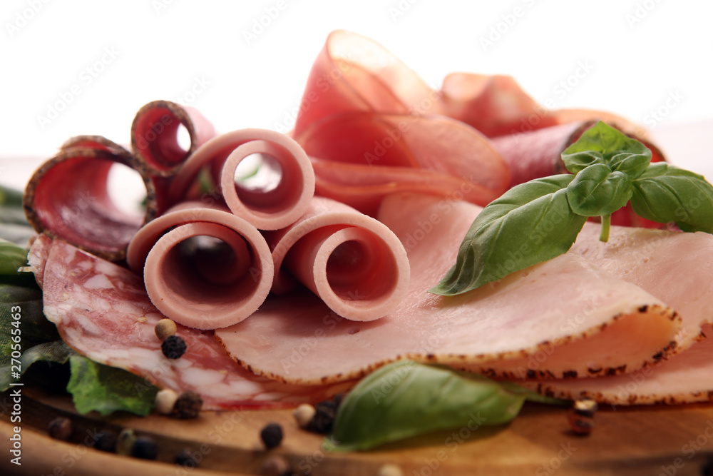 Food tray with delicious salami, pieces of sliced ham, sausages,salad and vegetable. Meat platter with selection Food tray with delicious salami, pieces of sliced ham, sausages,salad and vegetable. Meat platter with selection