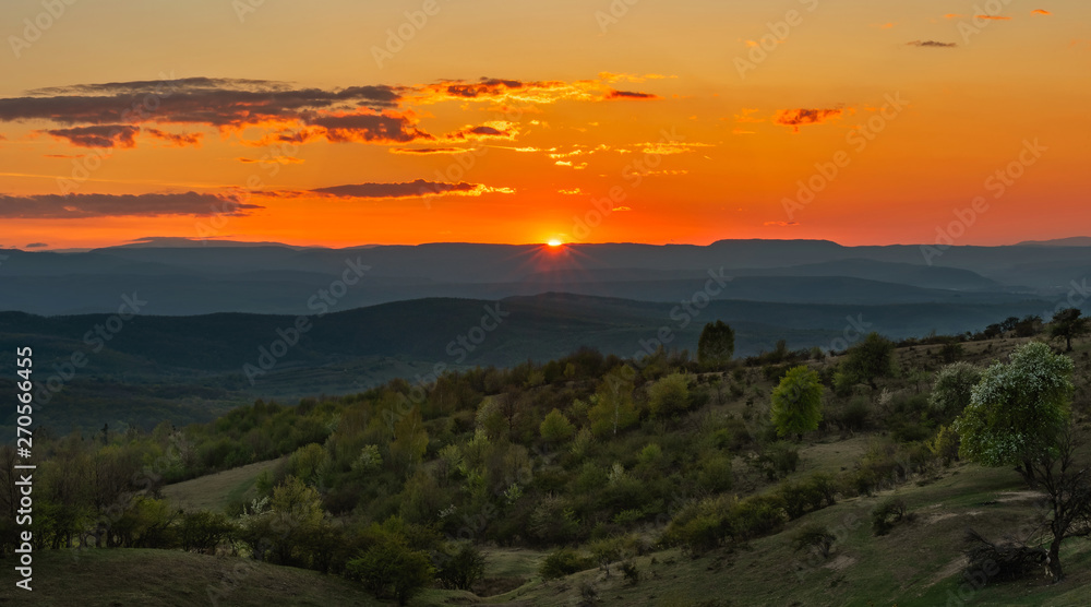 Spring Sunset over green mountains