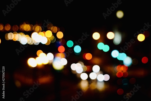 colorful bokeh lights in the street in the city at night © Ismael