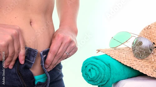 Woman fattened can't close blue jeans. Overweight girl with fat belly and too tight pants. Beach body ready series, slimming for Summer, losing weight before holidays, weight loss goals in summertime