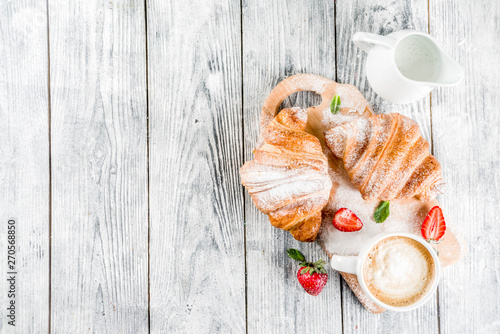 Breakfast concept with coffee and croissants