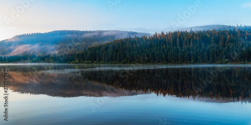 Mountain lake with fog and colorful sky, springtime 