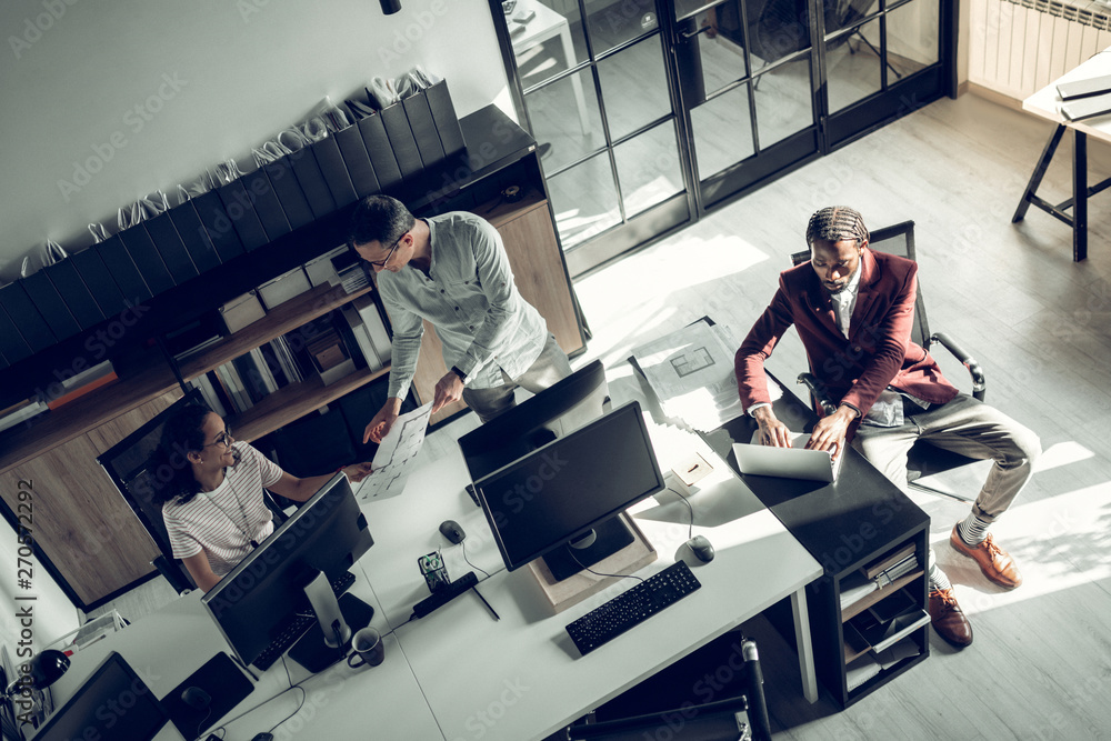 © Viacheslav Yakobchuk - Three successful businessmen working on project together