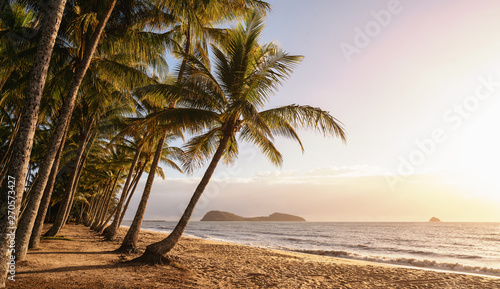 Fototapeta Naklejka Na Ścianę i Meble -  Panoramic view of an empty tropical beach at the sunrise with copy space