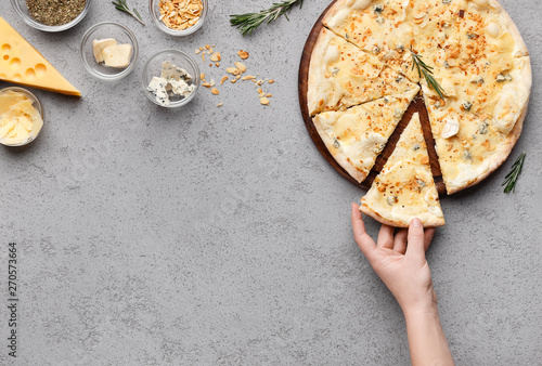 Girl Taking Piece Of Cheesy Pizza, Top View photo