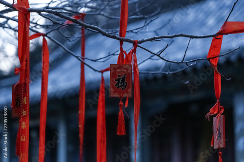 Chinese red cloth wooden brand for blessing.Props used by tourists to pray for good luck and fortune.It symbolizes good luck.The Chinese text means good luck and fortune. photo