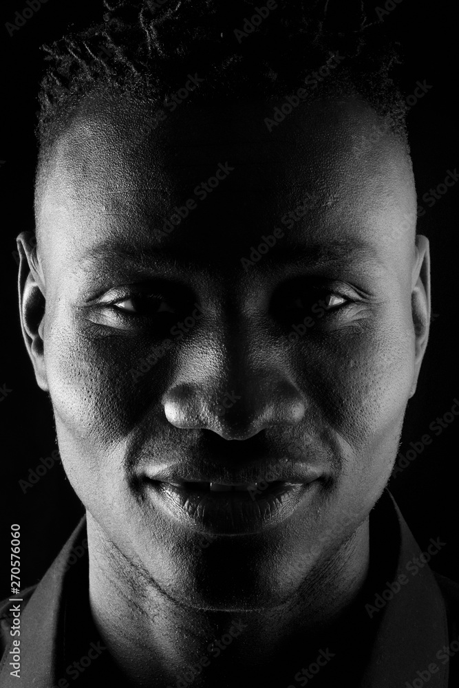 close up of portrait of a african man on black background close up of portrait of a african man on black background
