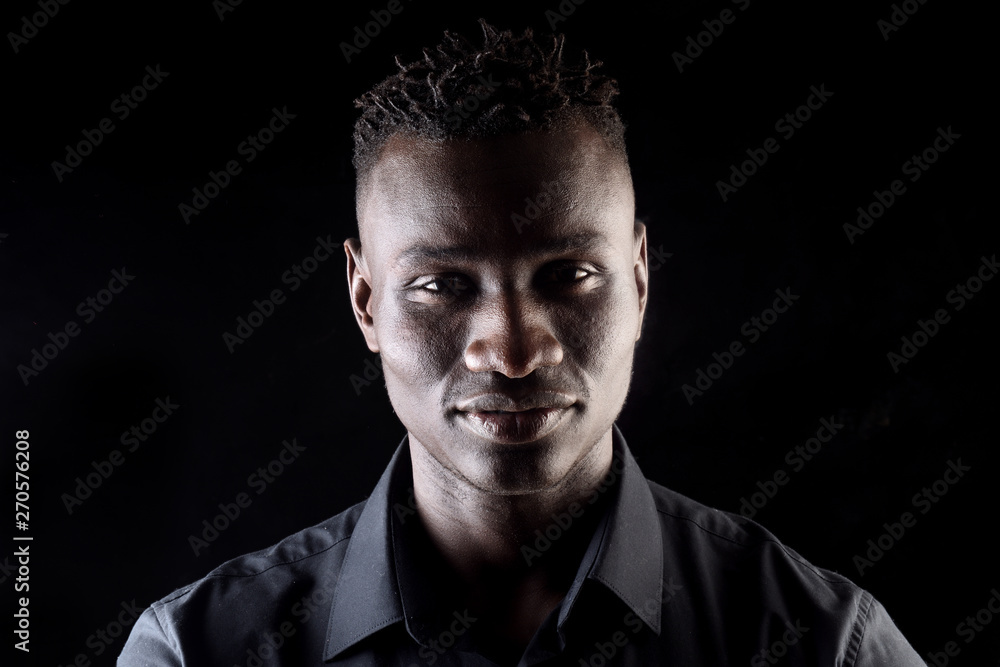 portrait of a african man on black background, serious portrait of a african man on black background, serious