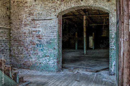 Inside a large brick factory sitting empty and abandoned