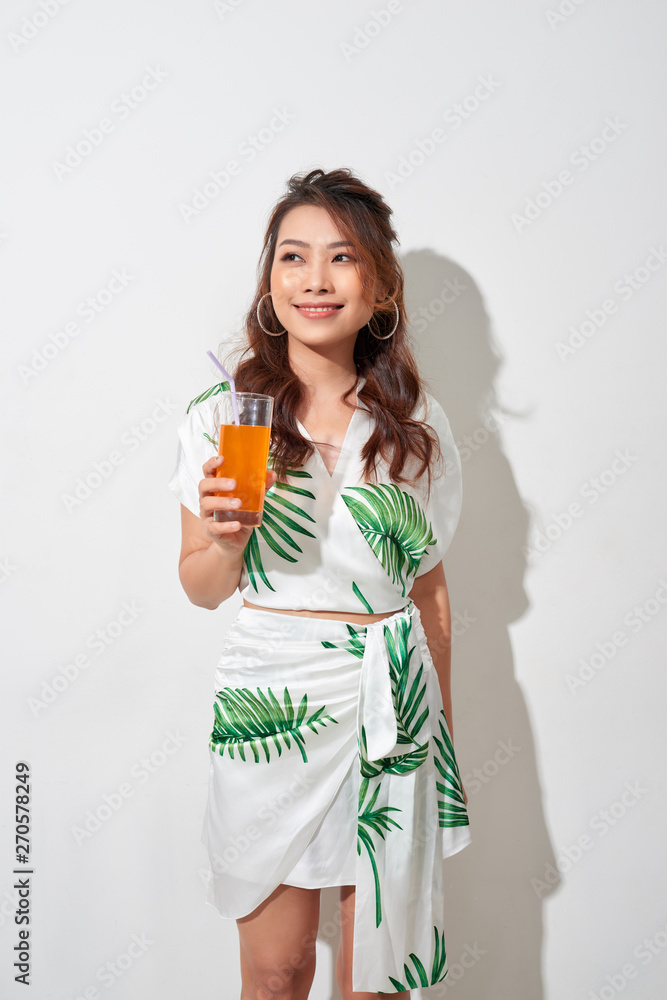 Happy Asian woman in summer casual clothes with a glass of fresh fruit juice drink Happy Asian woman in summer casual clothes with a glass of fresh fruit juice drink