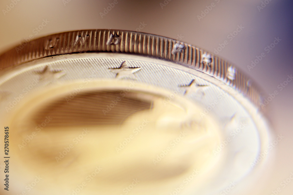 bimetallic coin backing 2 euro obverse from copper-nickel alloy with stars, close-up, macro photography bimetallic coin backing 2 euro obverse from copper-nickel alloy with stars, close-up, macro photography
