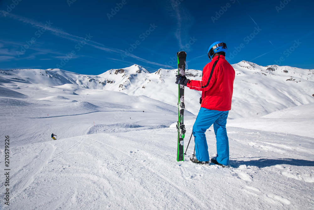 Skier posing in famous ski resort in Alps, Livigno, Italy, Europe.