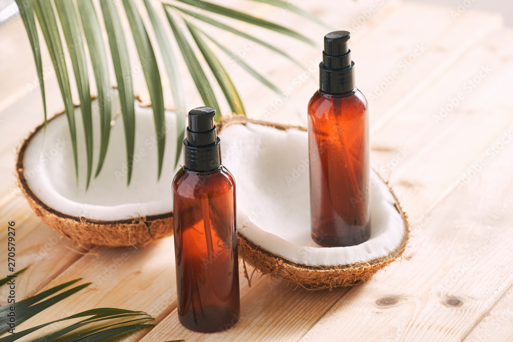 Coconut oil with fresh coconut for alternative therapy on wooden background Coconut oil with fresh coconut for alternative therapy on wooden background