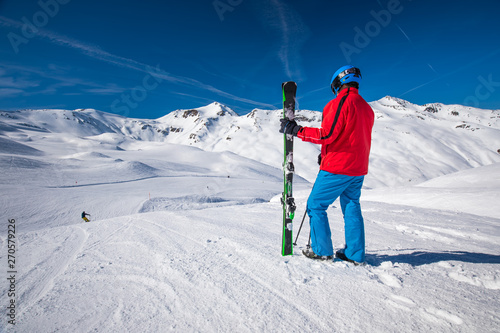 Skier posing in famous ski resort in Alps, Livigno, Italy, Europe.